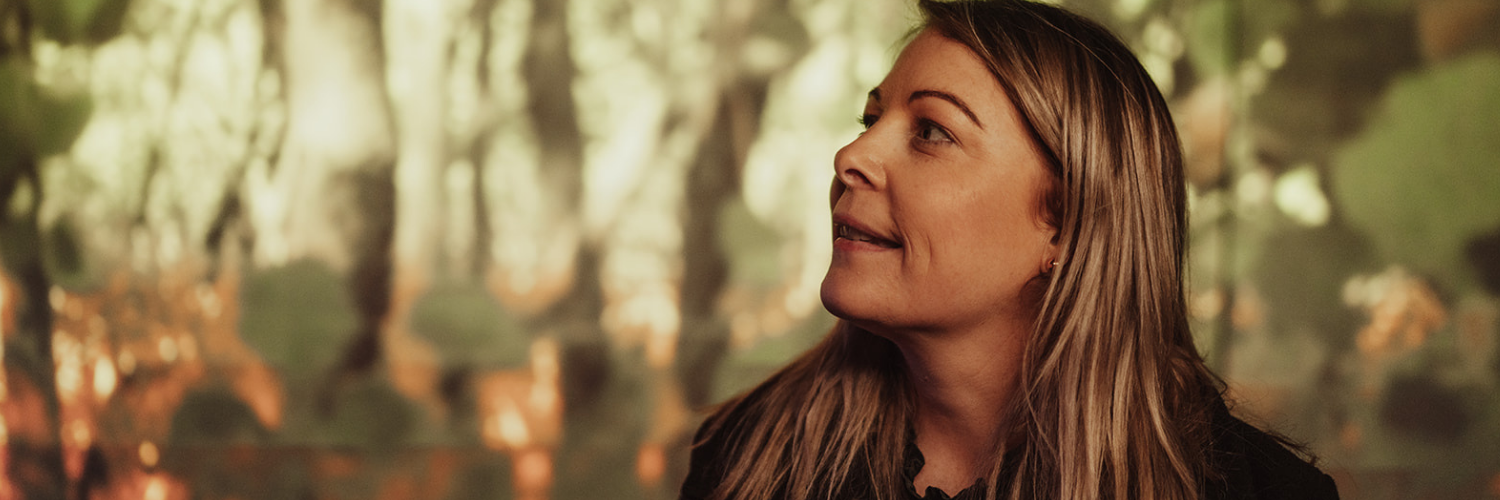 Immersive exhibit backdrop at Ned Kelly Discovery Hub featuring a forest-themed visual display.