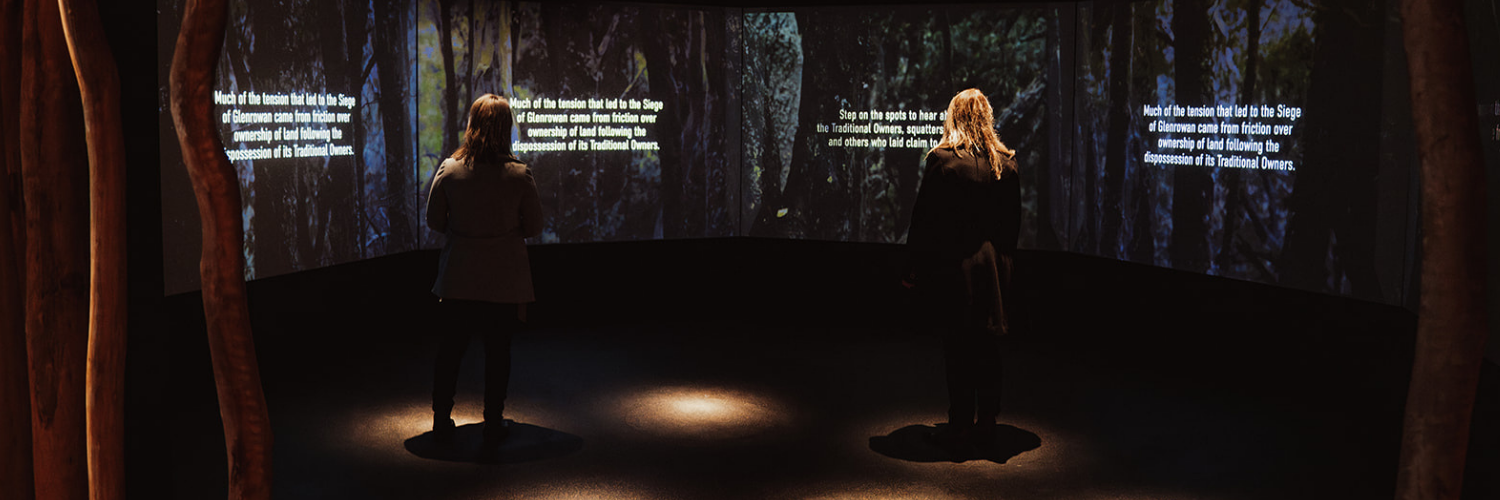 Immersive projection exhibit at Ned Kelly Discovery Hub displaying historical text about the Glenrowan siege.